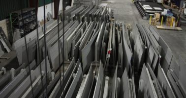 Stacked stainless plate in warehouse